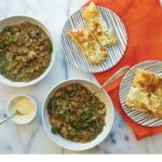 bowl of lentil stew with focaccia bread on the side