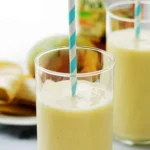 Two tropical smoothies with striped straws