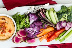 Roasted red pepper hummus with a platter of fresh vegetables