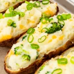 Twice-baked potatoes topped with cheddar, broccoli and green onion
