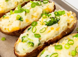 Twice-baked potatoes topped with cheddar, broccoli and green onion