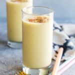 Two mango smoothies dusted with spice
