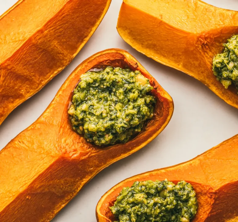 Roasted butternut squash halves stuffed with a green herb filling