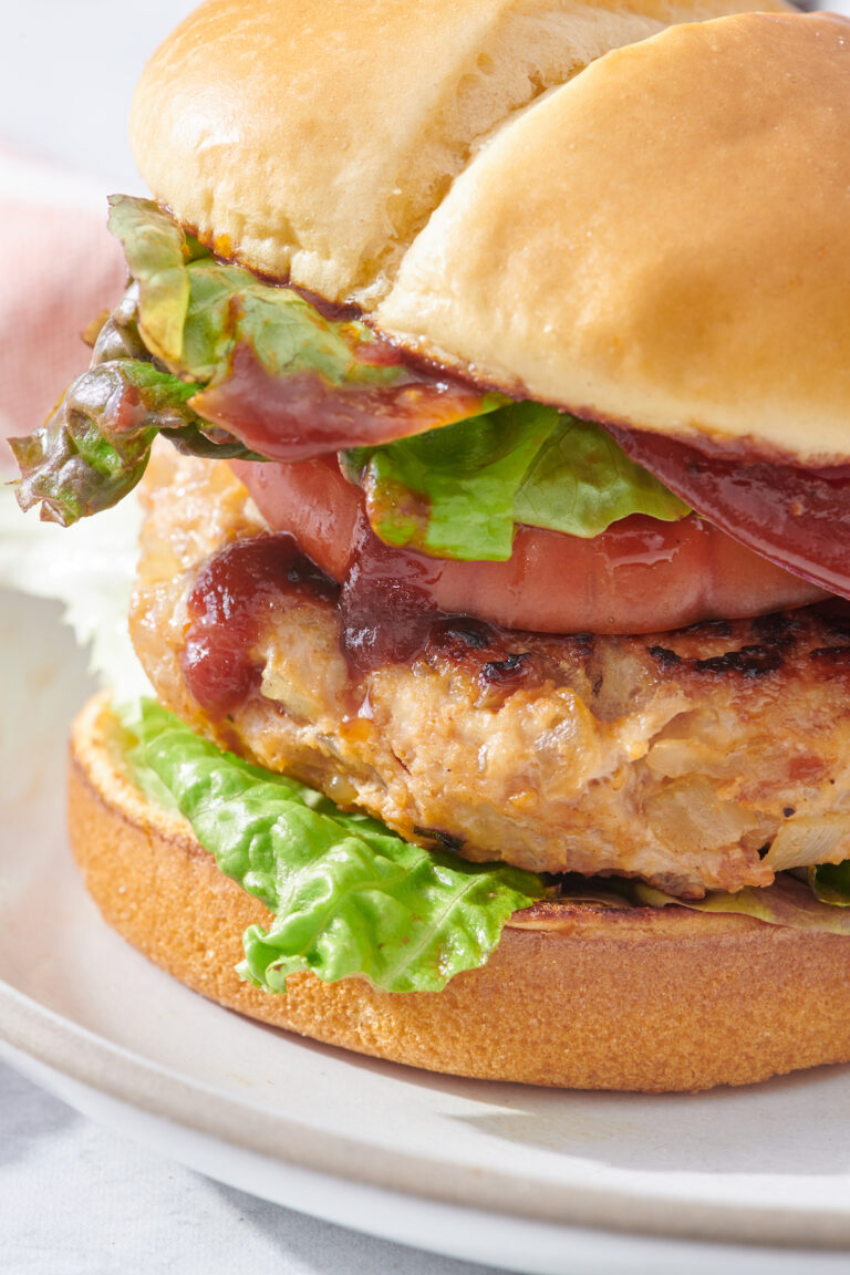 Barbecue chicken burger with lettuce and bacon on a bun