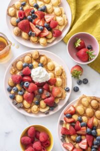 Bubble waffles topped with berries and whipped cream