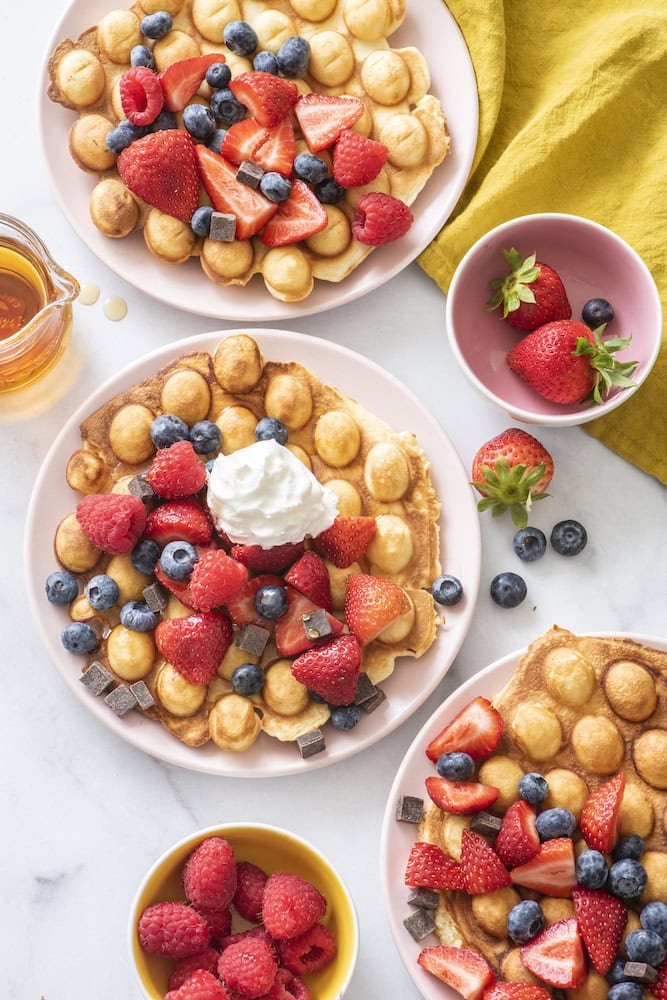 Bubble waffles topped with berries and whipped cream