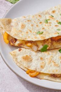 Chicken fajita quesadilla wedges with melted cheese and peppers