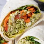 Chicken pesto wraps cut in half showing spinach and peppers