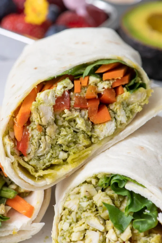 Chicken pesto wraps cut in half showing spinach and peppers
