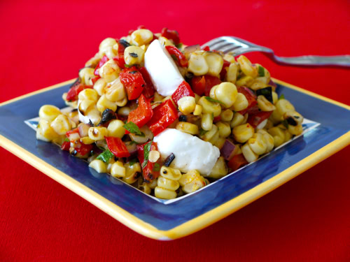 Grilled corn and red pepper salad on a blue plate