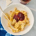 Matzah brei scrambled with eggs and topped with jam