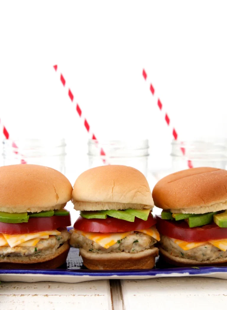Three Mexican chicken sliders with avocado and tomato