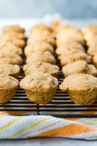 Rows of pumpkin apple muffins on a wire cooling rack