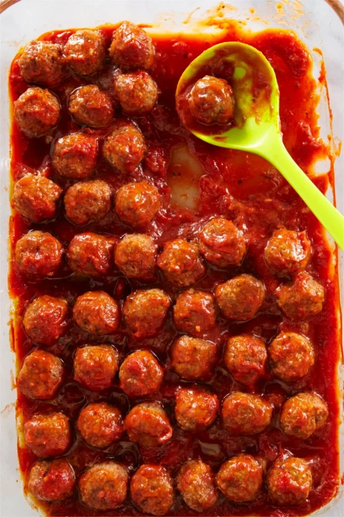 Turkey pesto meatballs baked in marinara in a dish