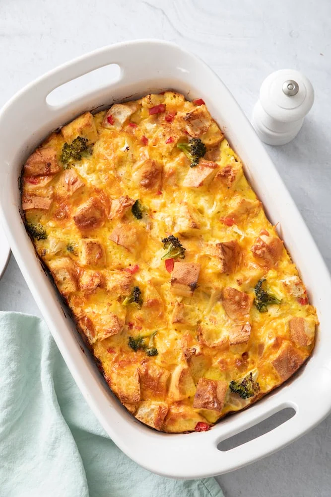 Baked vegetable strata in a white baking dish