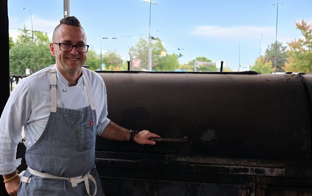 Chef Bob Bennett beside the smoker at Zingerman's Roadhouse