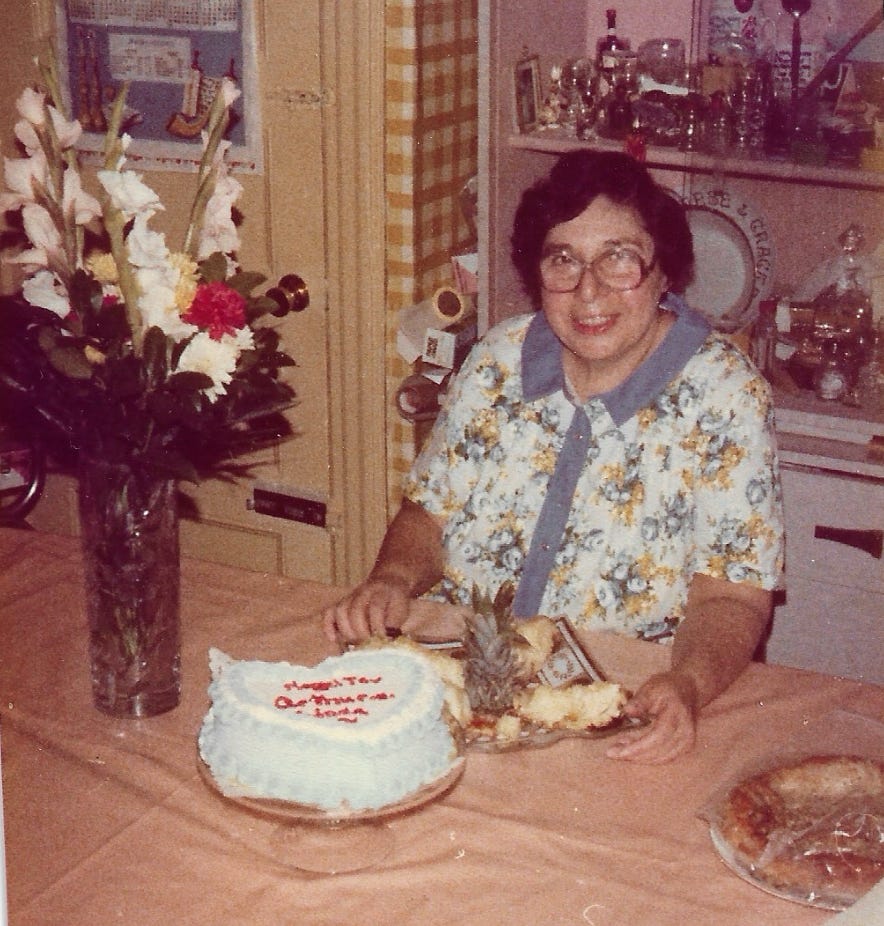 Ellen’s mother at a table with a decorated cake