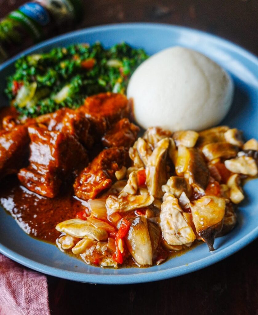 Tente with beef stew and chibwabwa mixed with bondwe, served na ka bwali on a blue plate