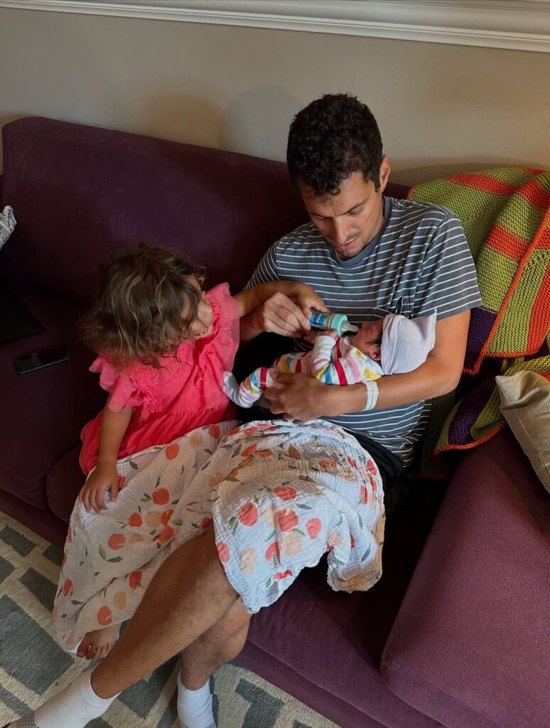 Danny’s husband Steve and their two daughters on the couch