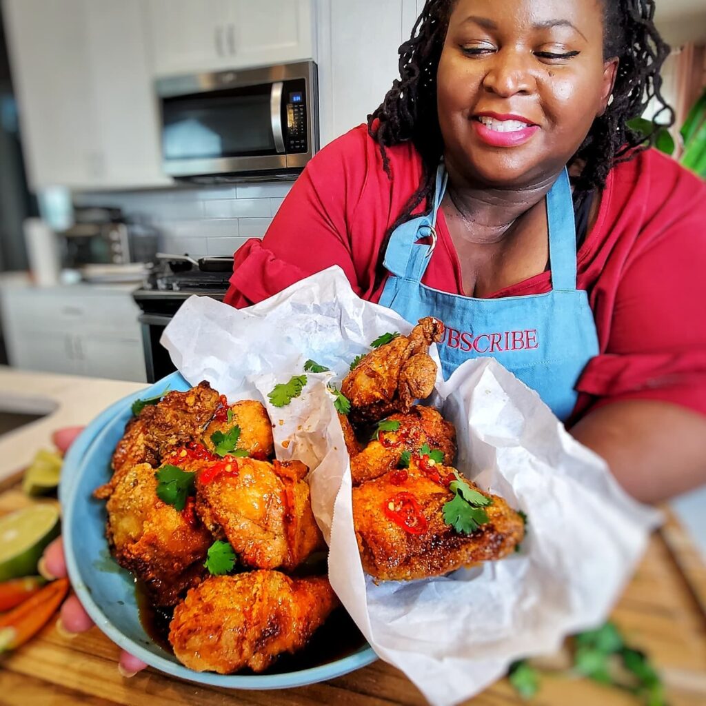 Demetra Overton presenting her air fried turkey wings in a blue bowl