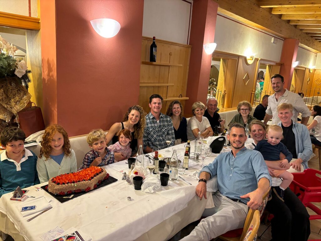 a large family of many generations posing for a picture at a restaurant