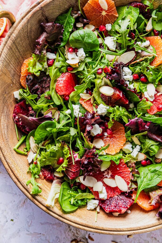 a large winter citrus salad in a wooden bowl