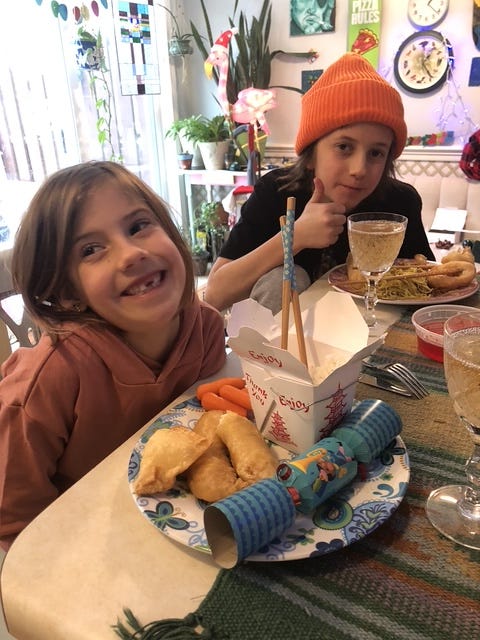 Emily’s kids at the table with Chinese takeout and Christmas crackers