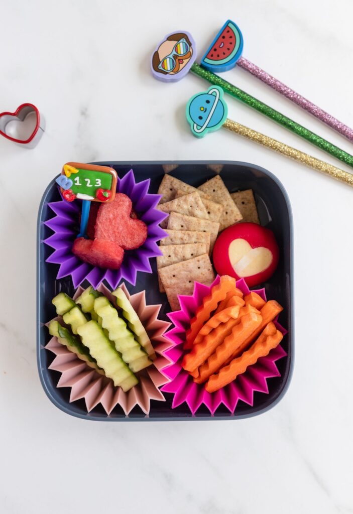 a snack box of veggies, crackers and cheese