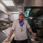 Chef Jason Dady standing in a restaurant kitchen