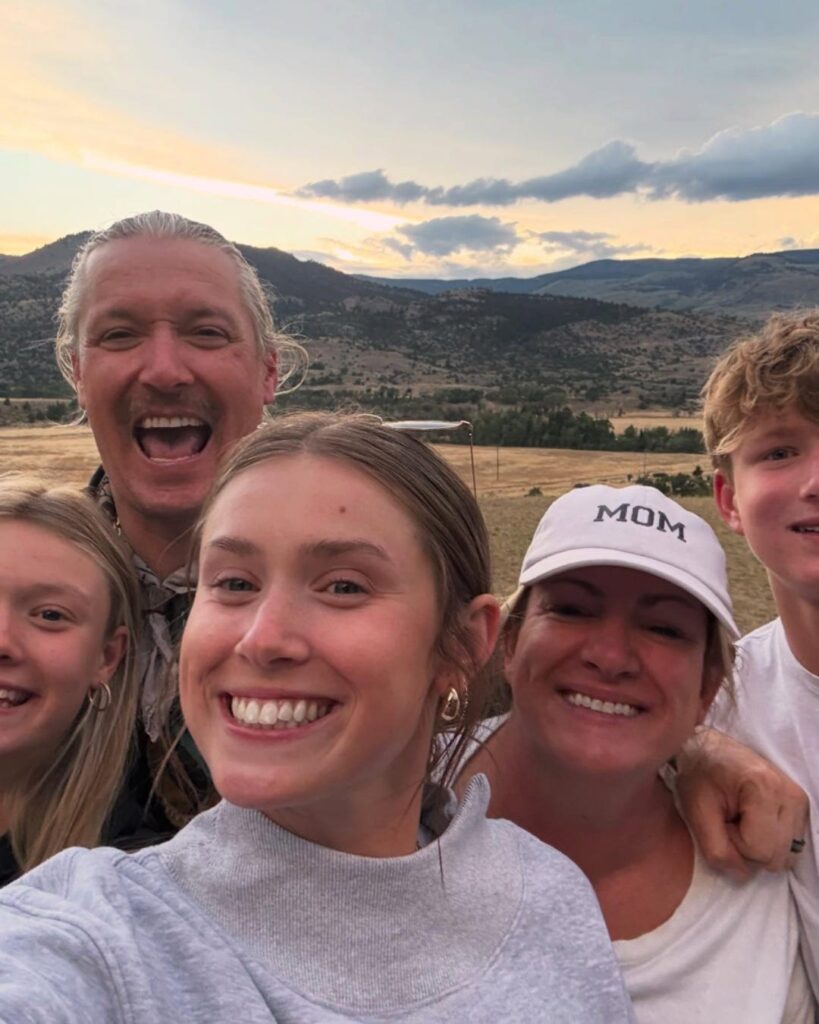 Chef Jason with his wife, Crystal, and their three kids posing for a picture in front of mountain range