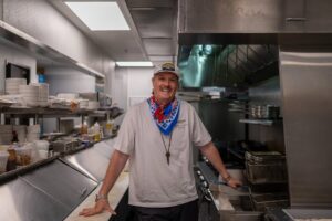 Chef Jason Dady standing in a restaurant kitchen