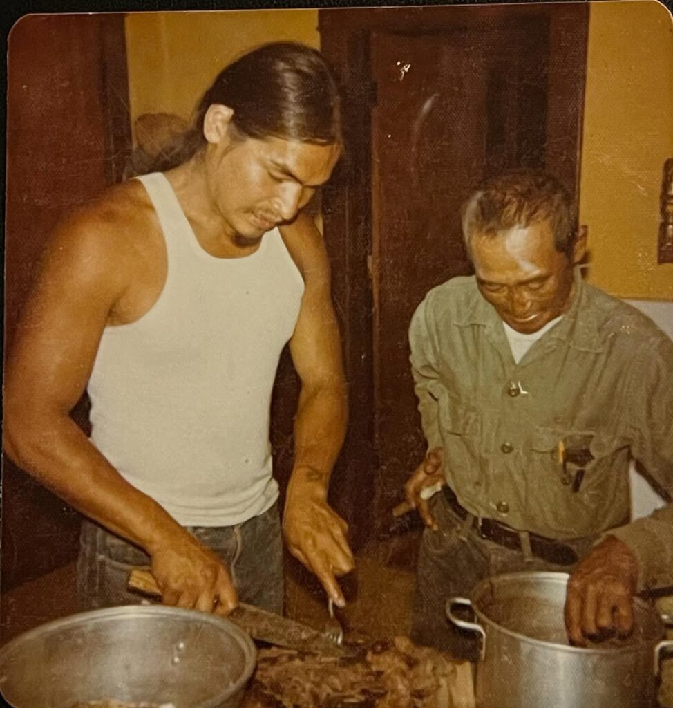 Jeremy’s father cutting a large portion of meat
