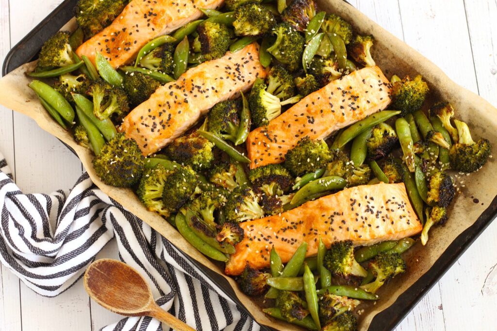 a dish of broccoli and snap peas with filet of salmon