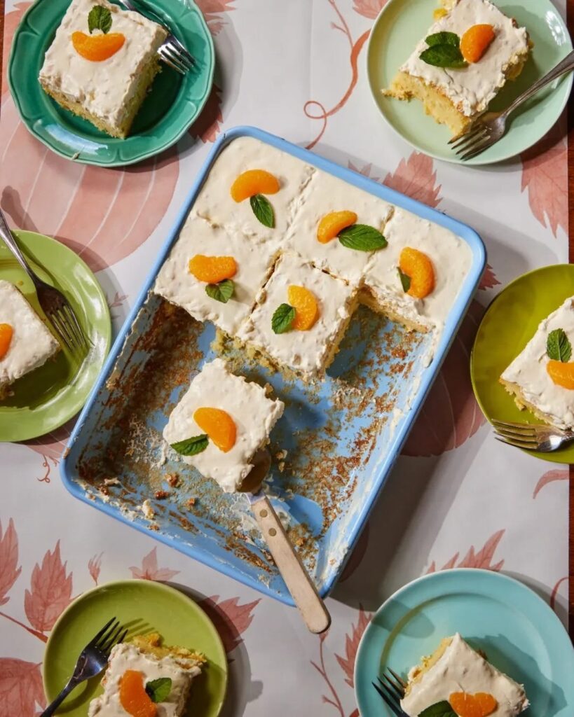 sliced up cake in a baking dish with colorful plates with slices of cake displayed on a floral table cloth