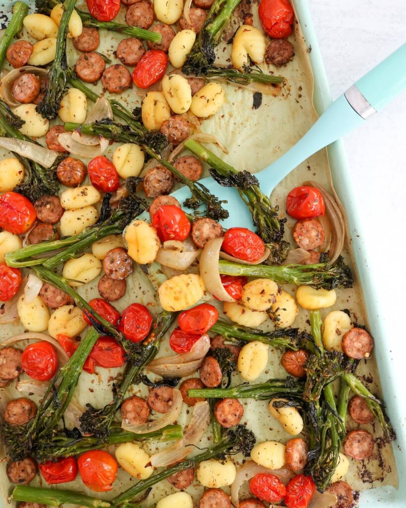Sheet pan of roasted gnocchi, sausage, cherry tomatoes and broccolini