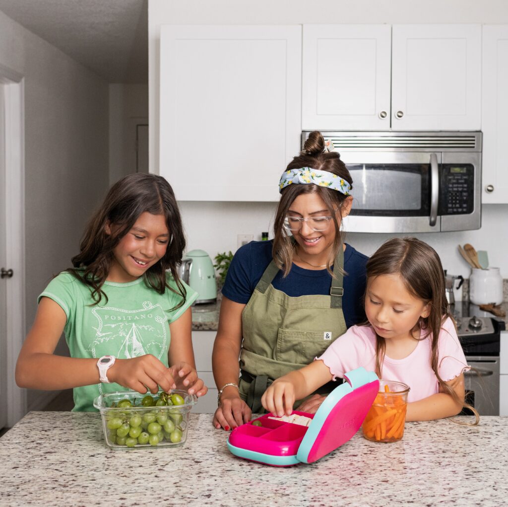 Kris and two daughters, Sage and Wren packing up a lunch box