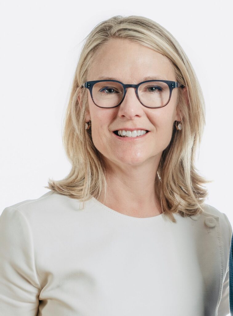 Lauren Driscoll, Founder & CEO of NourishedRX in white shirt and black glasses