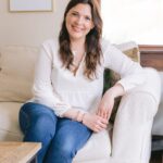 Lauren Kretzer sitting on a white couch