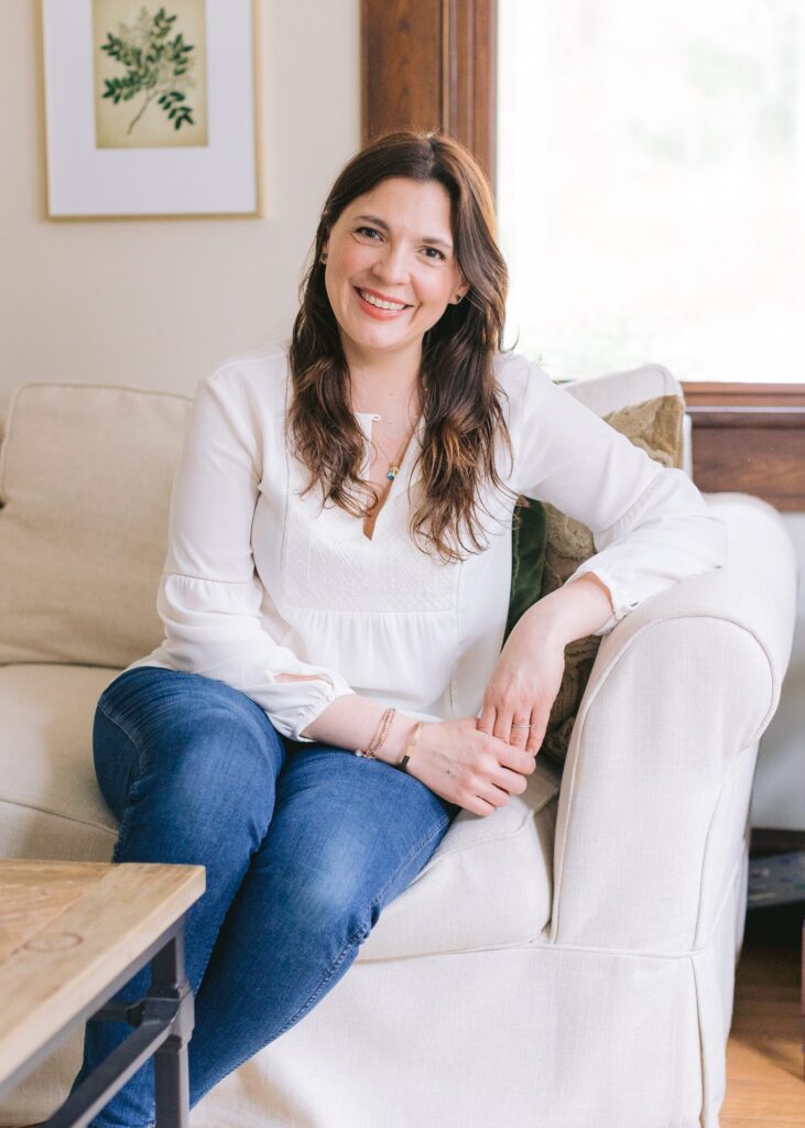 Lauren Kretzer sitting on a white couch