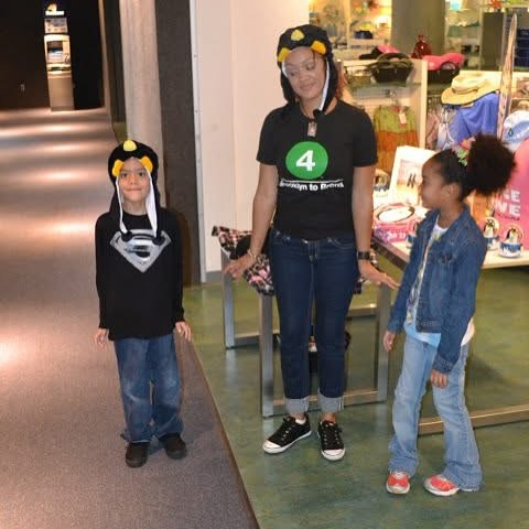 Marta with her twins standing outside a clothing store