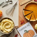 a kitchen counter top with sliced pumpkin pie and a bowl of mashed potatoes