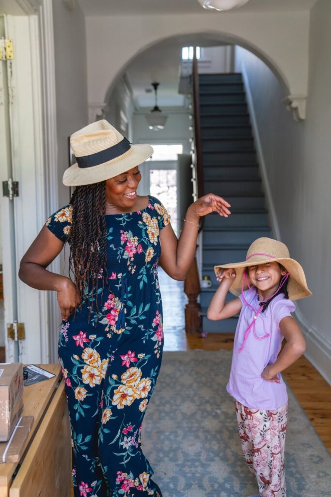 Maya and her daughter, when she was younger wearing sun hats