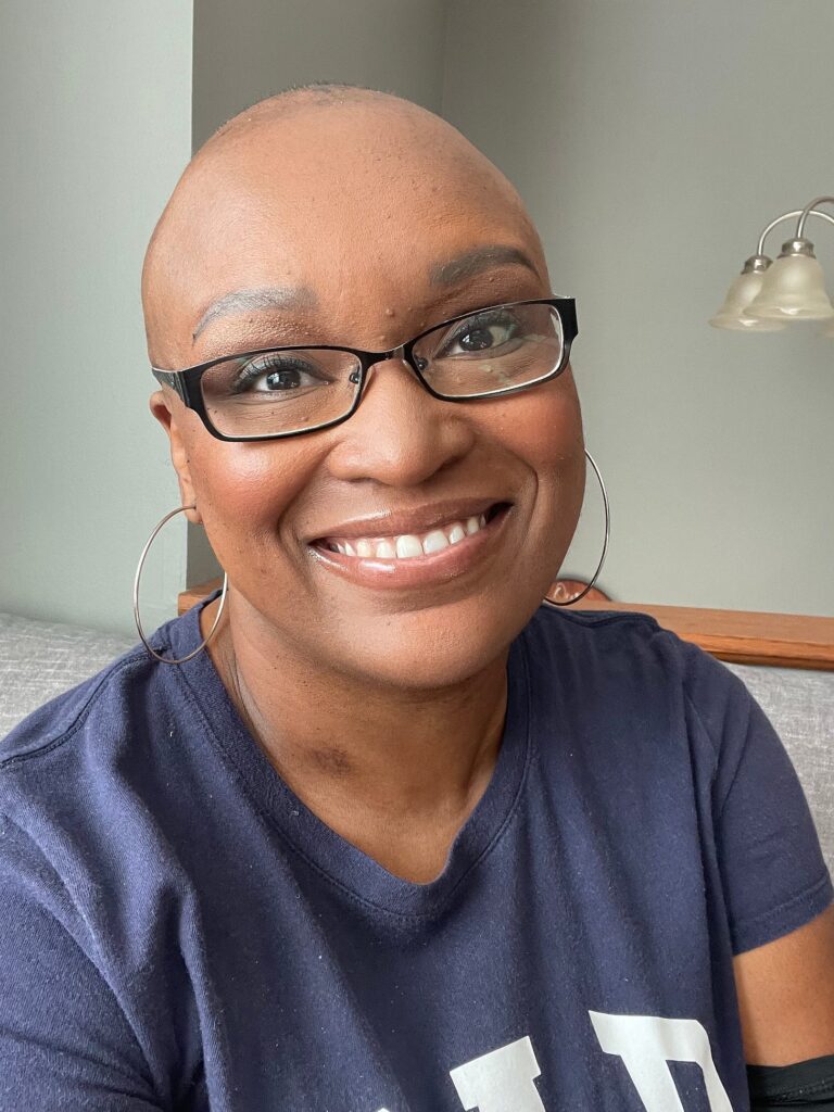 Nicole Washington wearing black glasses and smiling
