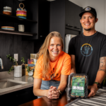 Rebecca Wickre and Ben Jacobs of Tocabe in a kitchen with a package of Tocabe food