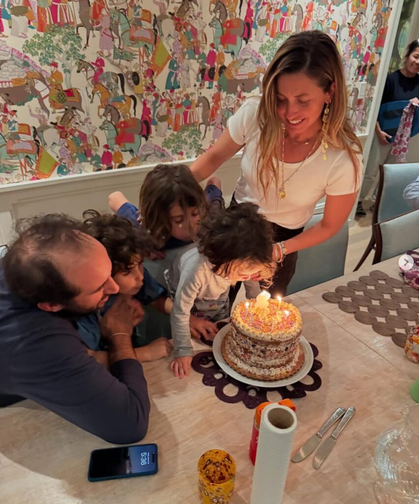 Sabrina Rudin and family blowing out birthday cake candles