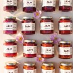 Rows of Ayako & Family plum jam jars with pink flowers