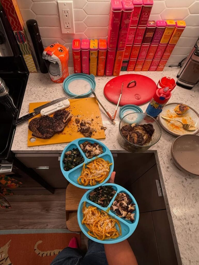 Cooking carrot saffron spaghetti on a kitchen counter with Diaspora Co. spice tins