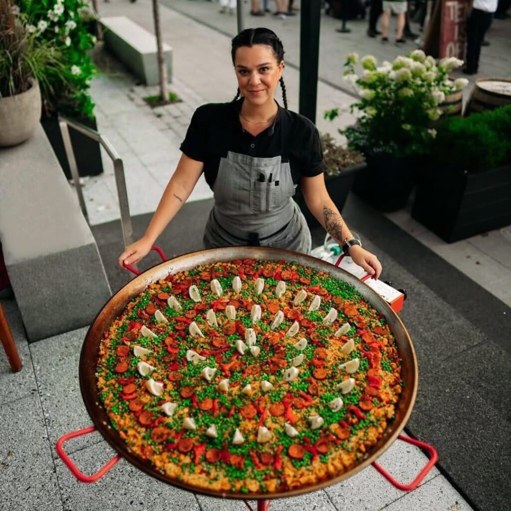 Chef Tatiana Rosana with a giant pan of paella