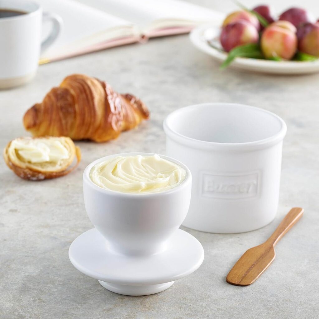 White butter bell, countertop ceramic butter keeper with a croissant in the background