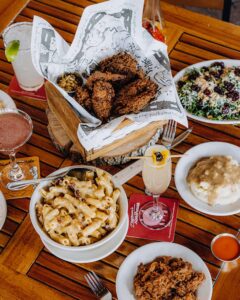 A table set with bbq chicken and mac and cheese